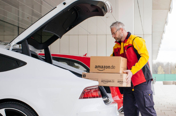 DHL delivery man placing Amazon package in trunk – New Amazon delivery pilot program