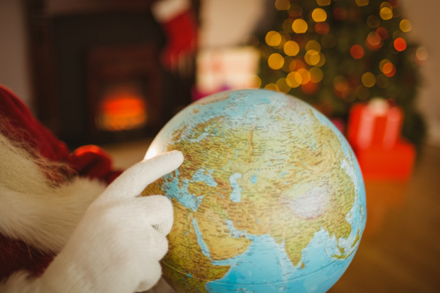 Santa holding a globe - international shipping deadlines for 2015 holiday season.