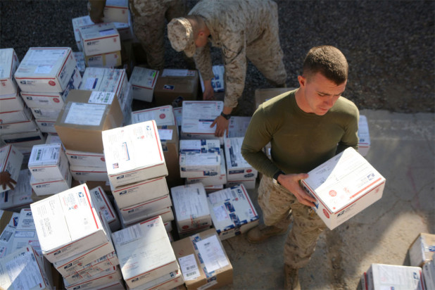 Military men picking up USPS Priority Mail boxes – how to create and ship military care packages