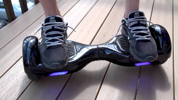 Person standing on hoverboard – USPS restricting the shipment of ground hoverboards due to product fires