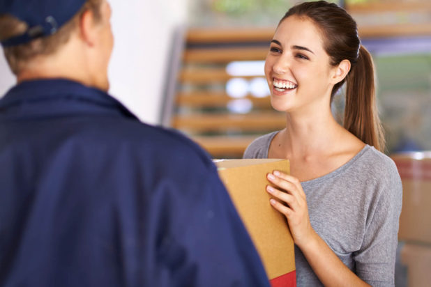 man delivering box to smiling woman