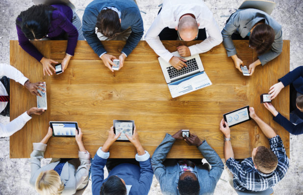 group of people viewing social media on varying devices